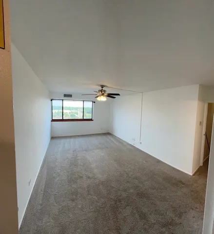 an empty room with windows and mirror view