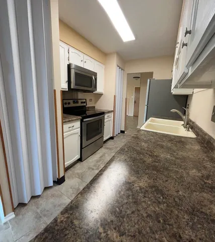 a view of a kitchen with microwave and stove