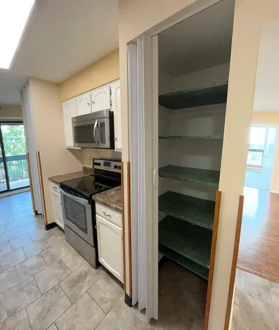 a kitchen with a refrigerator stove and microwave