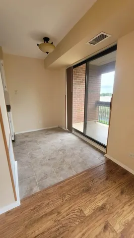 a view of an empty room with glass door