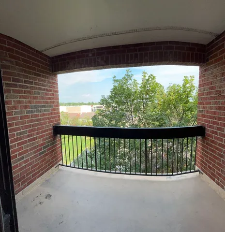 a view of balcony and floor to ceiling window