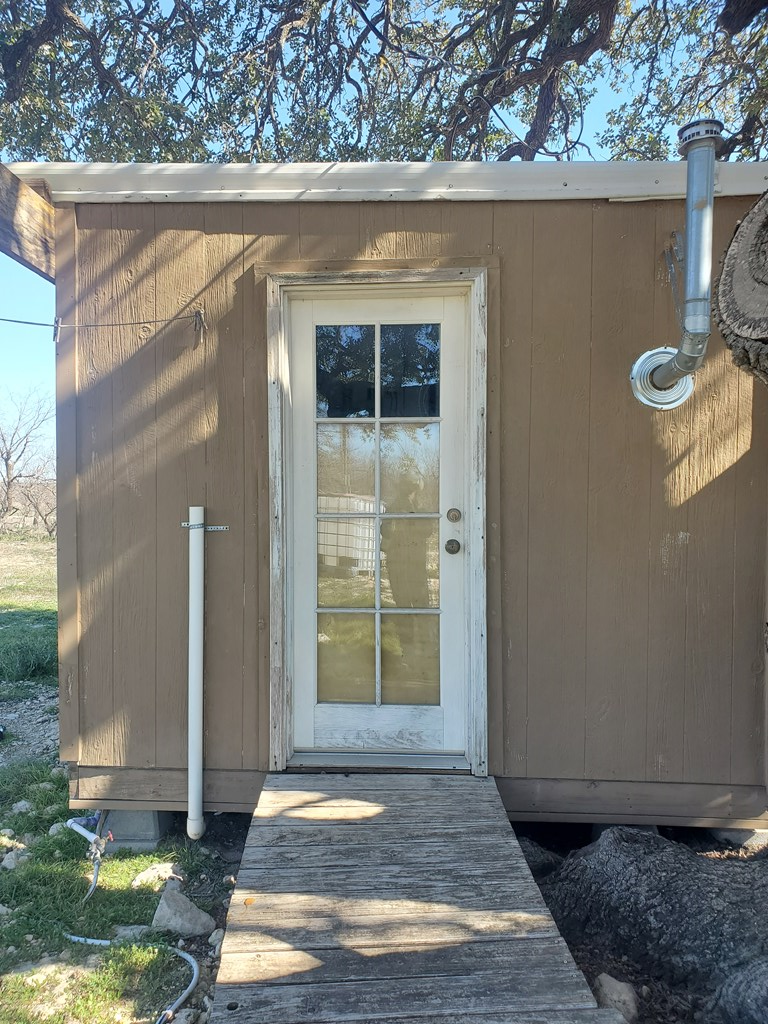 3567 Cave Wells Road, Unit 1721 Fort McKavett, TX 76841 - Photo 15 of 16 a front view of a house with garden
