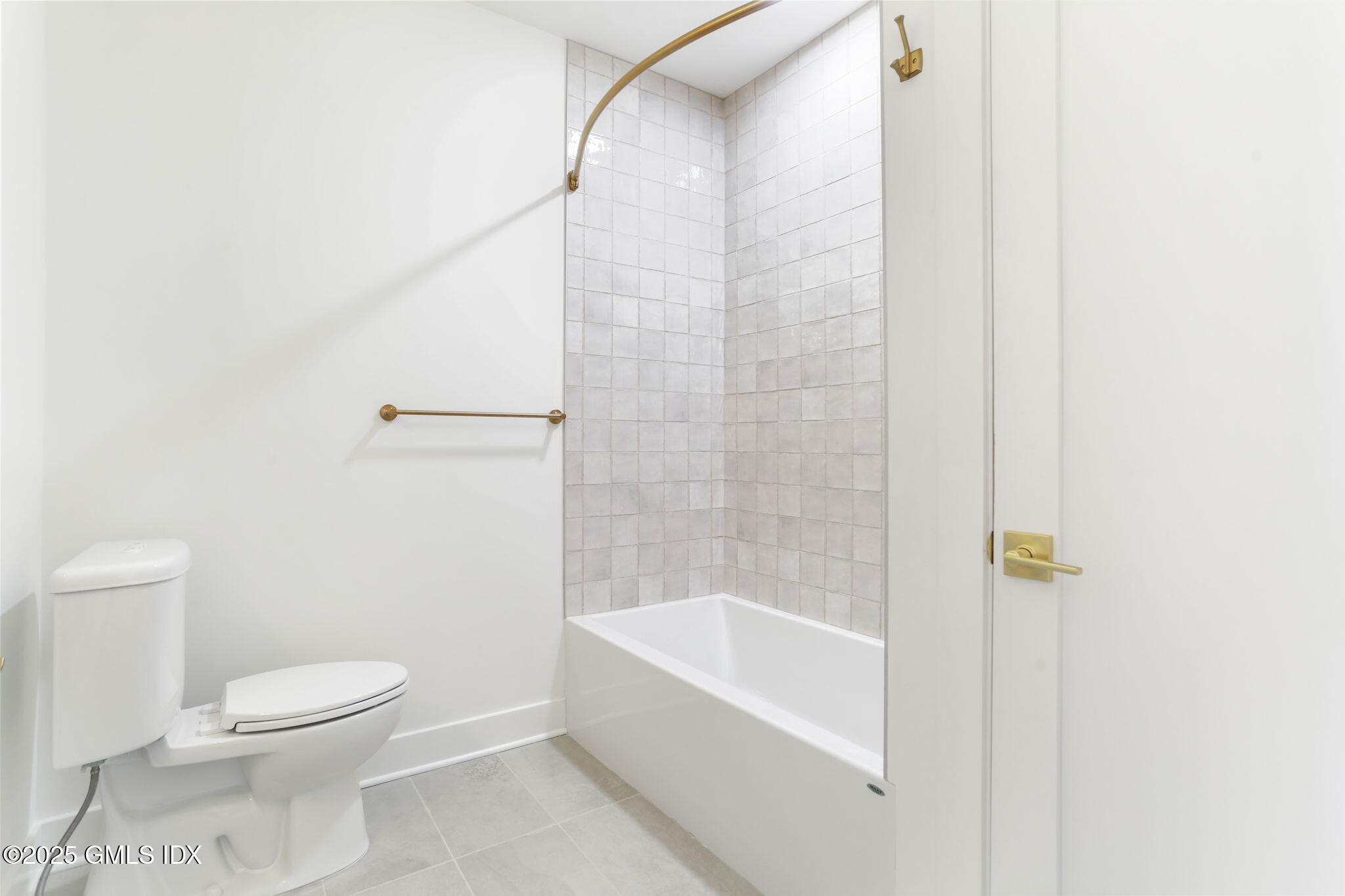 100 East Putnam Avenue, Unit 210 Cos Cob, CT 06807 - Photo 19 of 27 a bathroom with a toilet and a bathtub