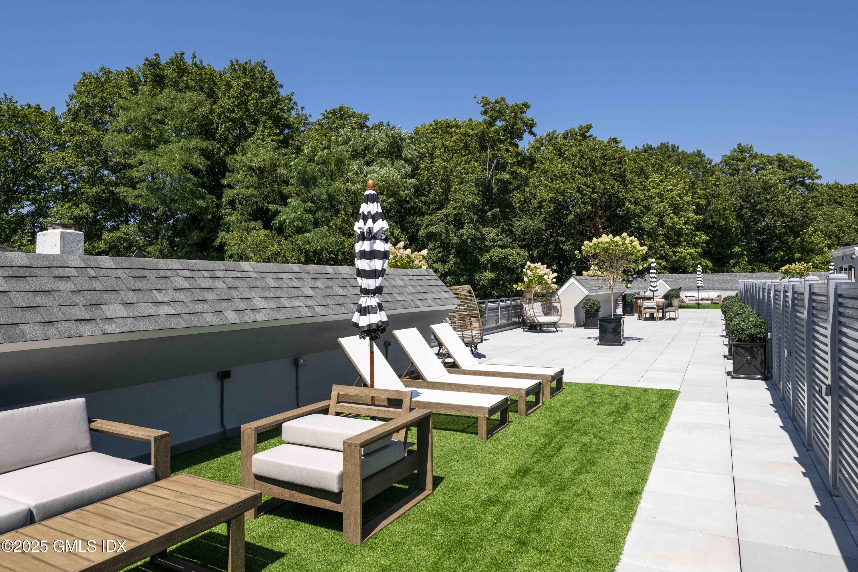 100 East Putnam Avenue, Unit 210 Cos Cob, CT 06807 - Photo 26 of 27 a view of a patio with chairs and a table