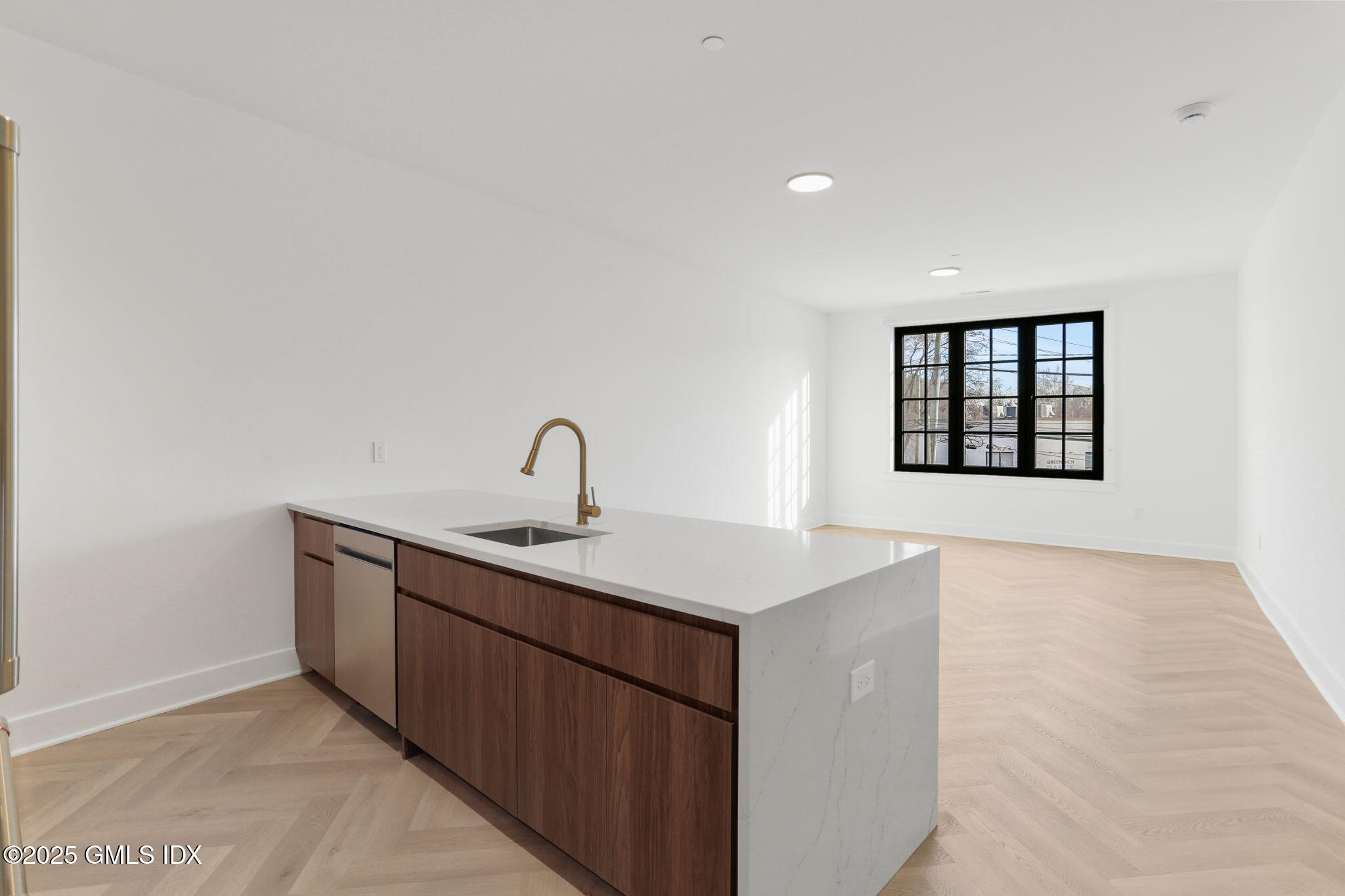 100 East Putnam Avenue, Unit 210 Cos Cob, CT 06807 - Photo 4 of 27 a kitchen with a sink cabinets and a window