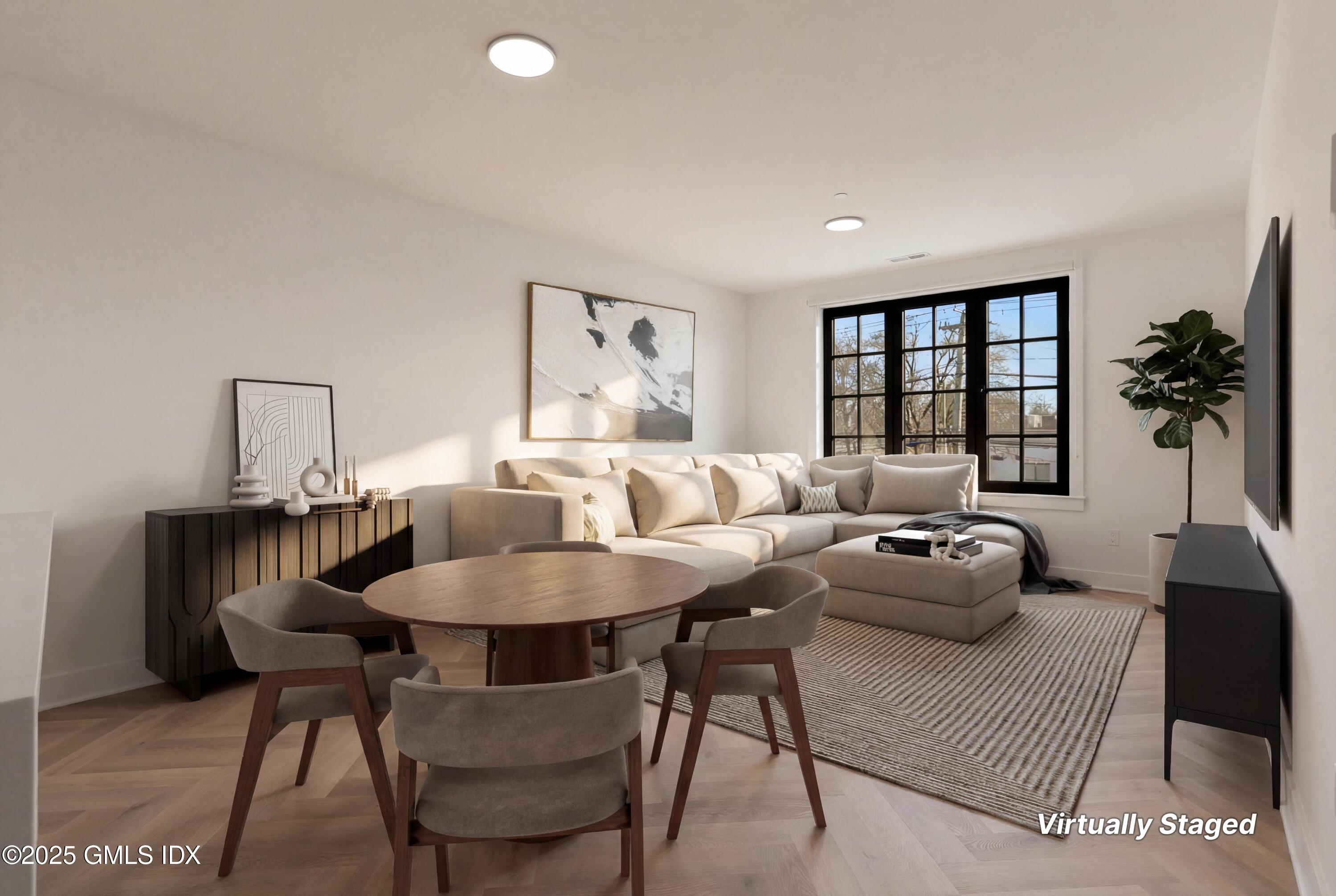 100 East Putnam Avenue, Unit 210 Cos Cob, CT 06807 - Photo 5 of 27 a living room with furniture and a table