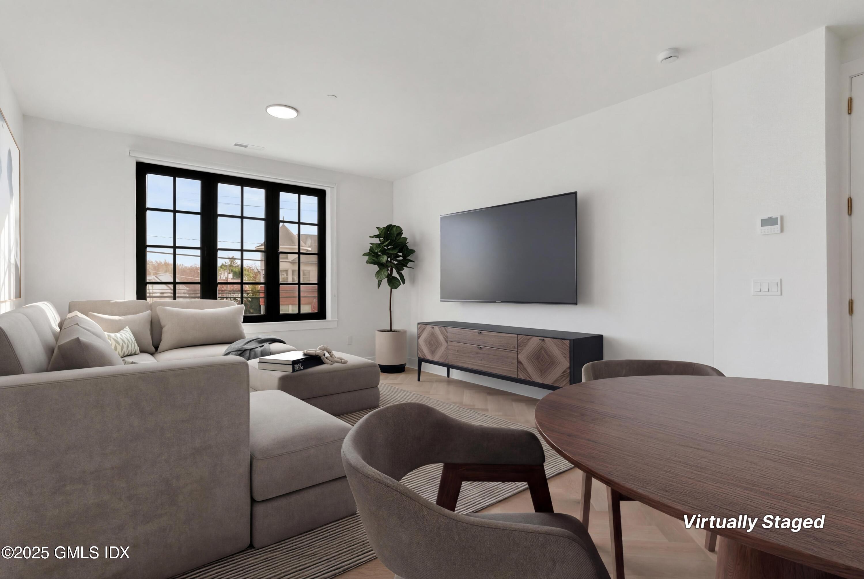 100 East Putnam Avenue, Unit 210 Cos Cob, CT 06807 - Photo 7 of 27 a living room with furniture and a flat screen tv