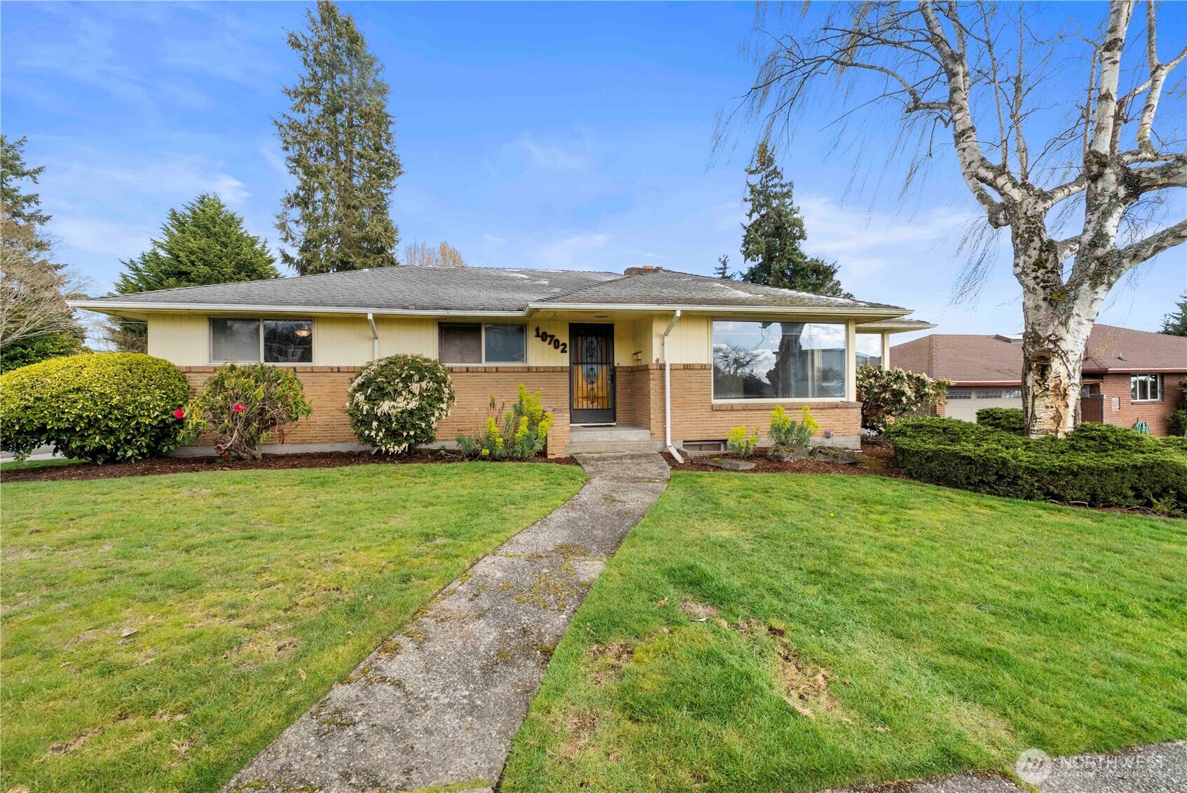 a front view of house with yard and green space