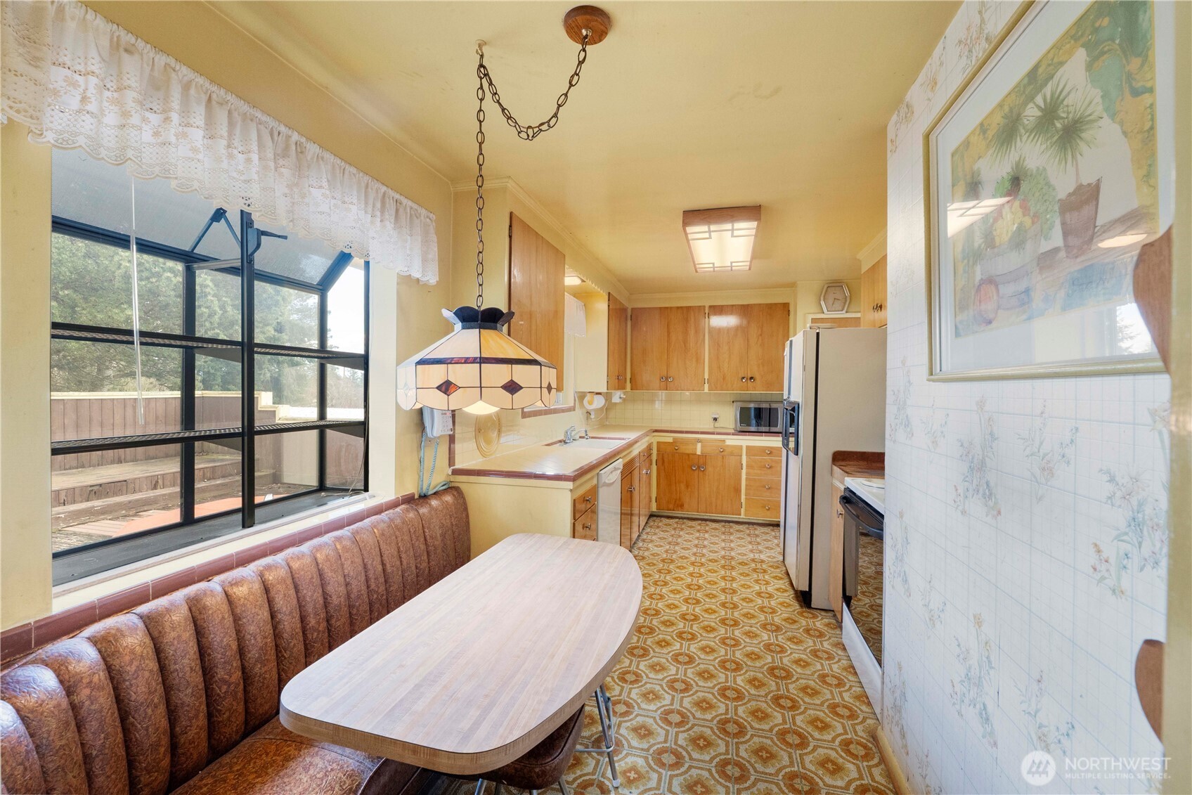 10702 39th Avenue Southwest Seattle, WA 98146 - Photo 11 of 40 a living room with furniture a rug and kitchen view