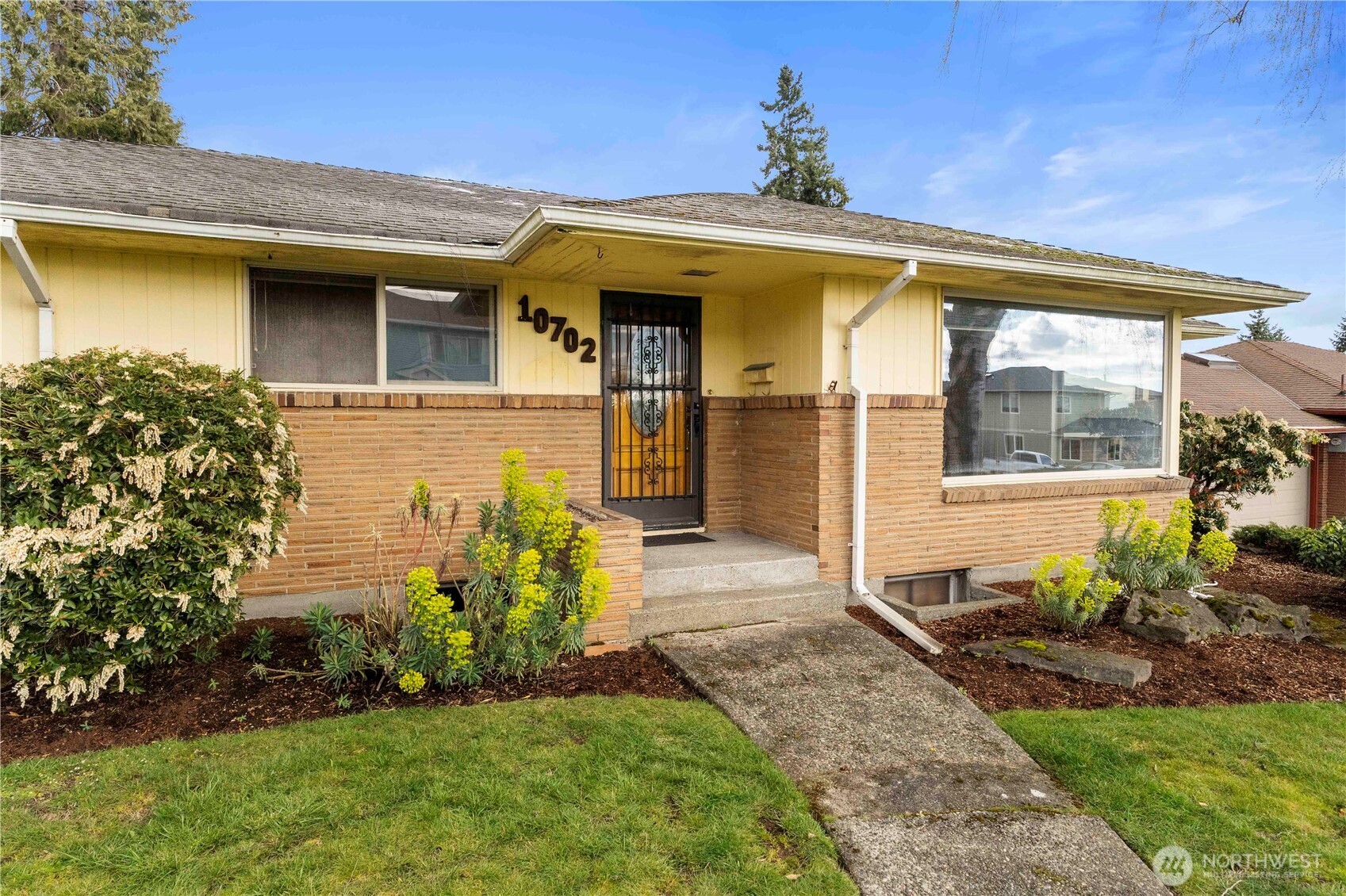 10702 39th Avenue Southwest Seattle, WA 98146 - Photo 2 of 40 a front view of a house with a yard
