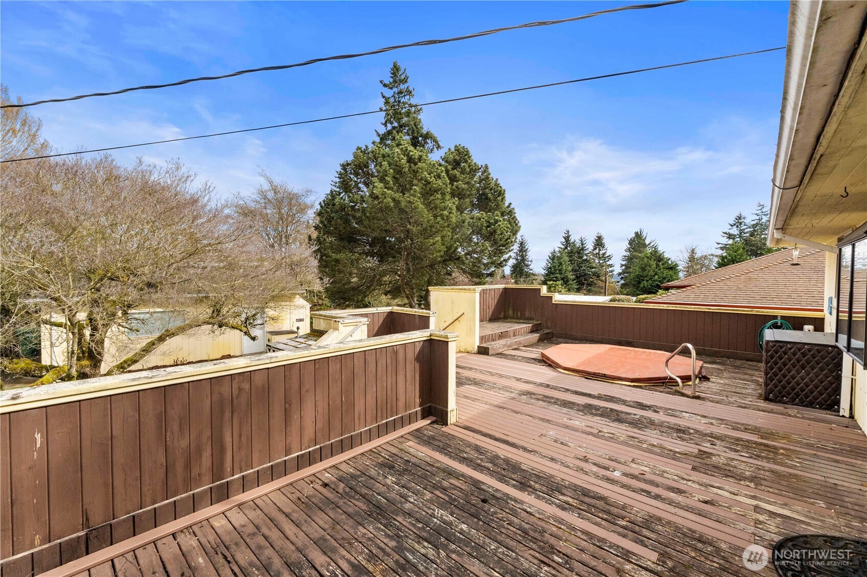 10702 39th Avenue Southwest Seattle, WA 98146 - Photo 29 of 40 a view of a balcony with chair and wooden floor