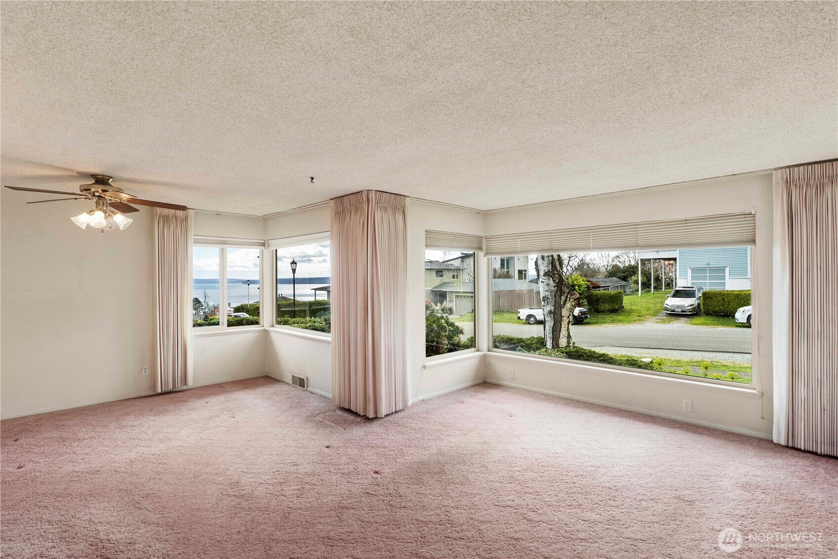 10702 39th Avenue Southwest Seattle, WA 98146 - Photo 6 of 40 a view of an empty room with a floor to ceiling window and an empty room