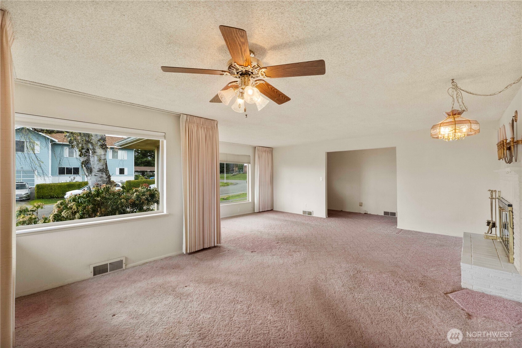 10702 39th Avenue Southwest Seattle, WA 98146 - Photo 10 of 40 a view of a livingroom with a ceiling fan and window