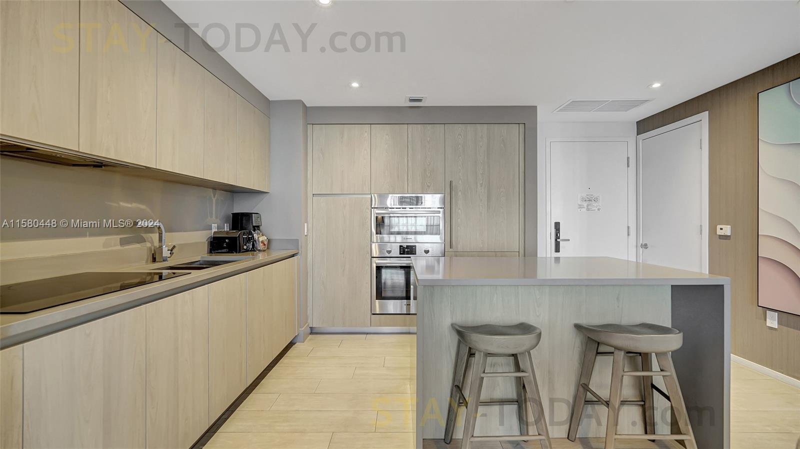 4010 South Ocean Drive, Unit R805 Hollywood, FL 33019 - Photo 12 of 36 a kitchen with stainless steel appliances a sink and cabinets