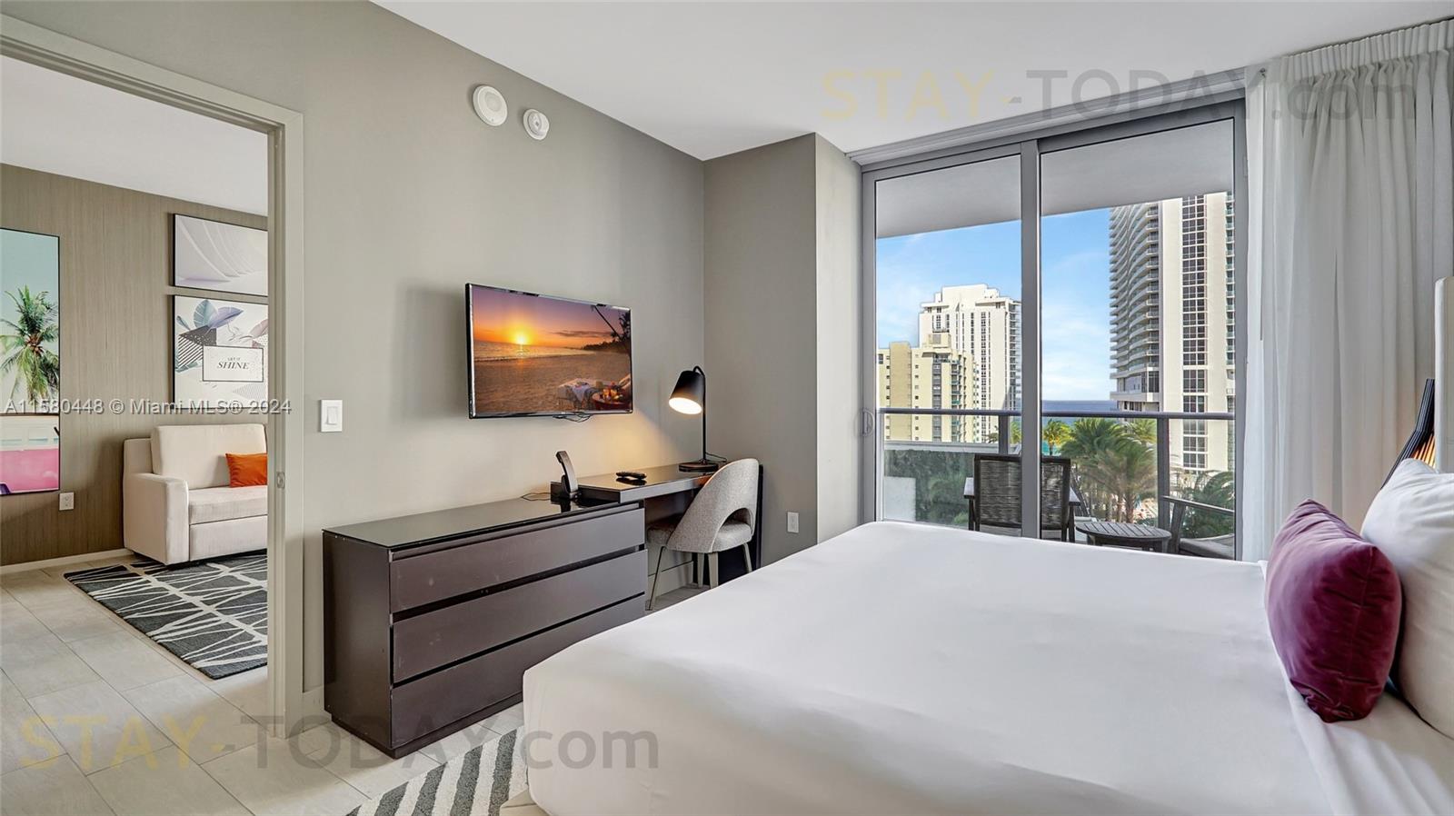 4010 South Ocean Drive, Unit R805 Hollywood, FL 33019 - Photo 15 of 36 a bedroom with a bed and large windows