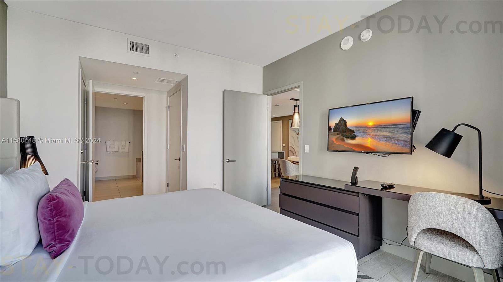 4010 South Ocean Drive, Unit R805 Hollywood, FL 33019 - Photo 17 of 36 a bedroom with a bed and a flat screen tv