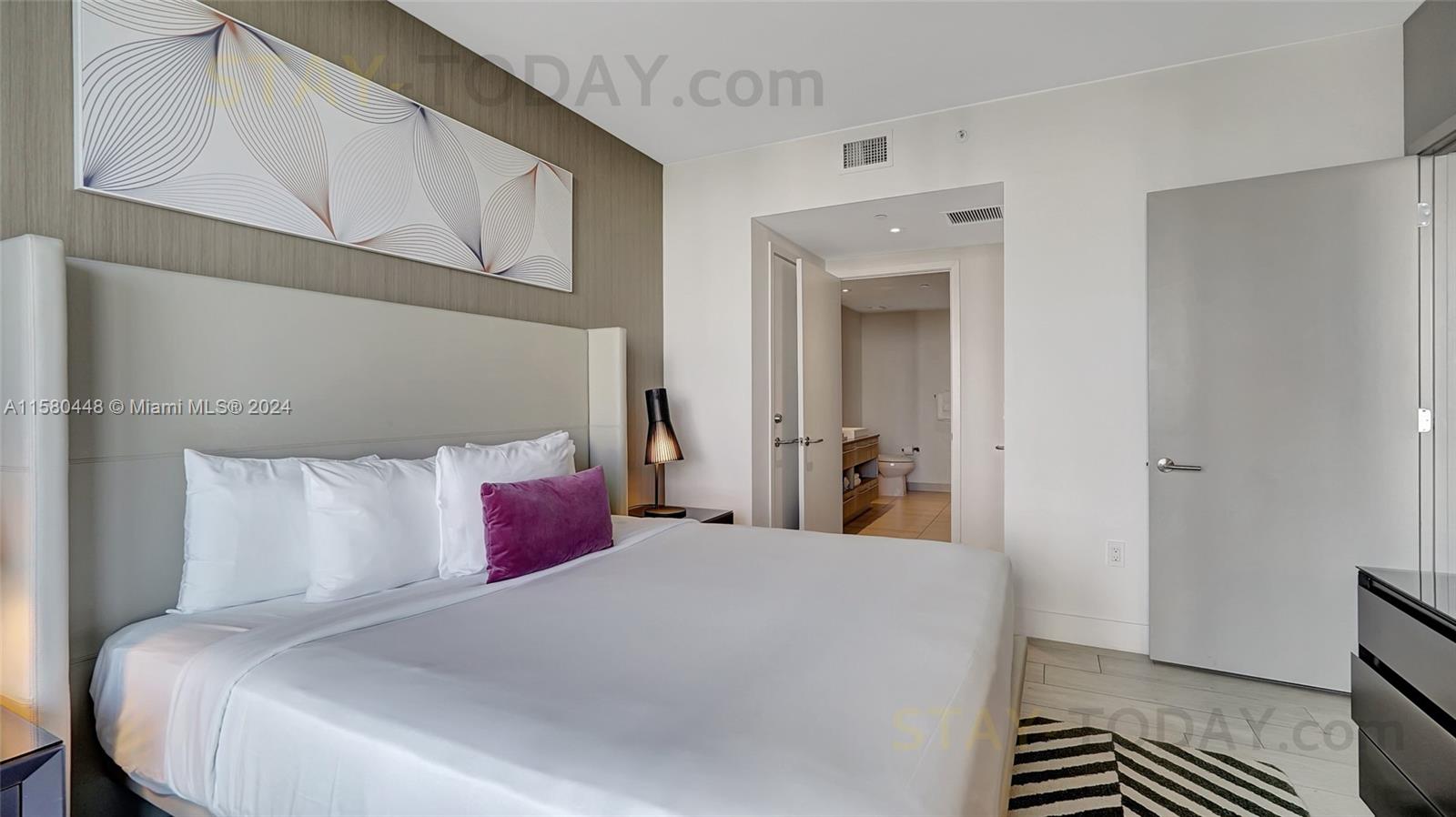 4010 South Ocean Drive, Unit R805 Hollywood, FL 33019 - Photo 18 of 36 a bedroom with a large bed and a window