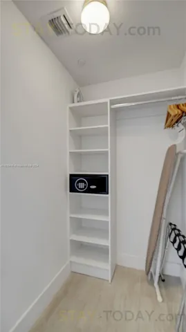 a view of walk in closet with empty racks