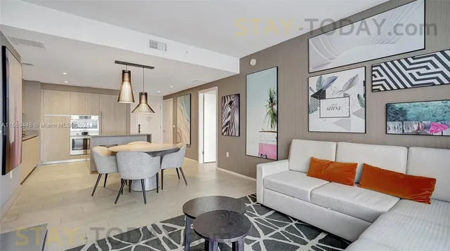 a dining room with furniture and wooden floor