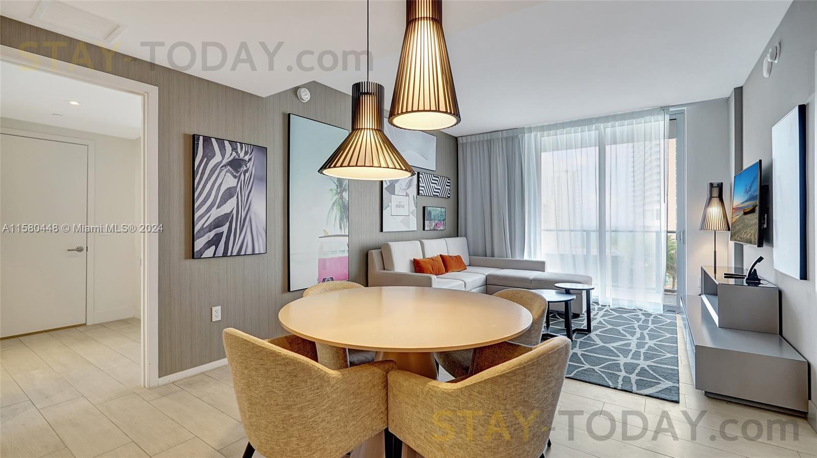 4010 South Ocean Drive, Unit R805 Hollywood, FL 33019 - Photo 4 of 36 a table and chairs in a room