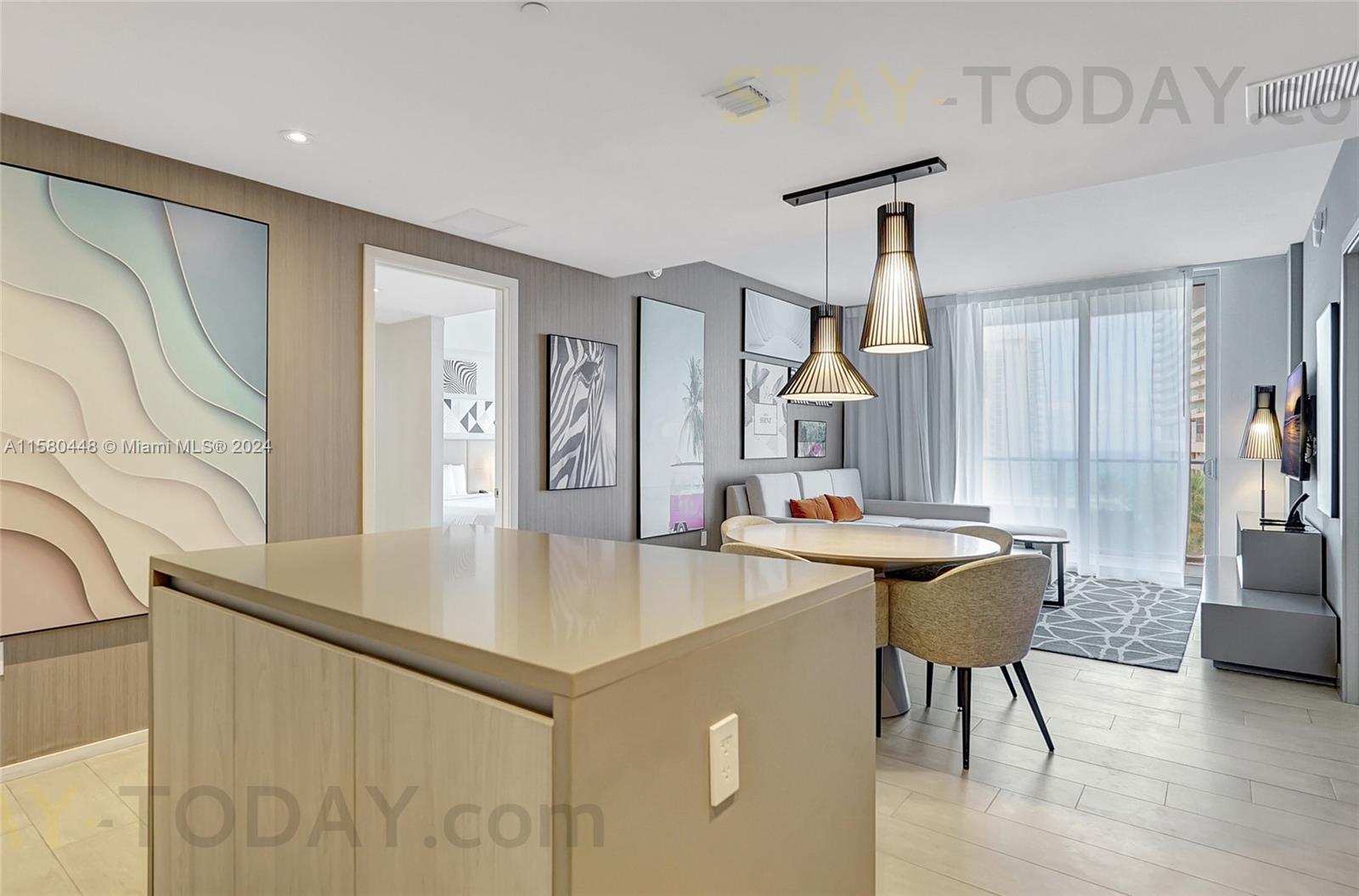 4010 South Ocean Drive, Unit R805 Hollywood, FL 33019 - Photo 9 of 36 a view of a kitchen with a table and chairs