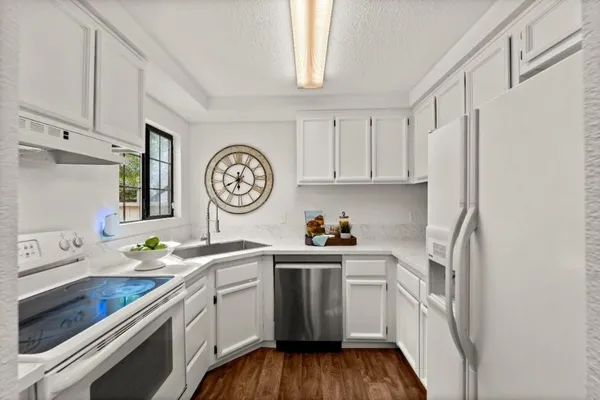a kitchen with stainless steel appliances a white cabinet and a refrigerator