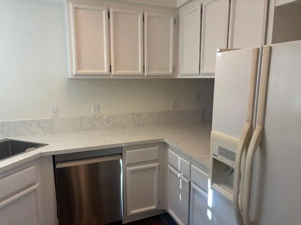 a kitchen with appliances and cabinets