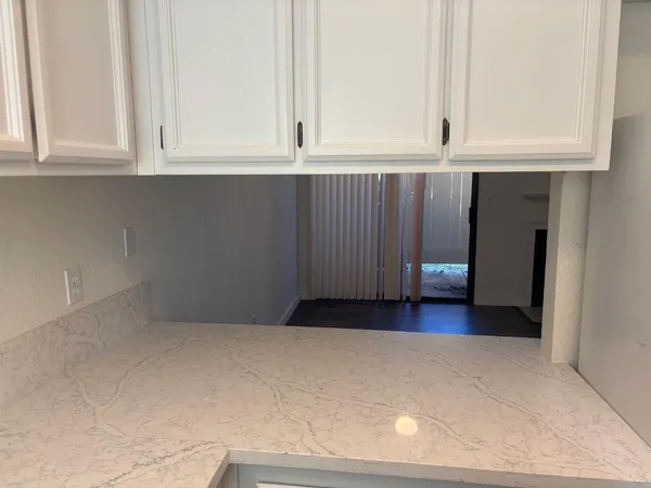 a view of cabinets and wooden floor