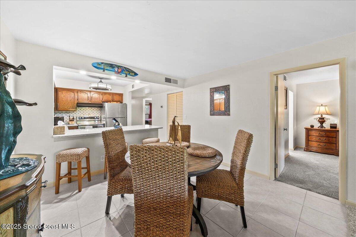 1700 South Atlantic Avenue, Unit 104 Cocoa Beach, FL 32931 - Photo 11 of 55 a view of a dining room with furniture