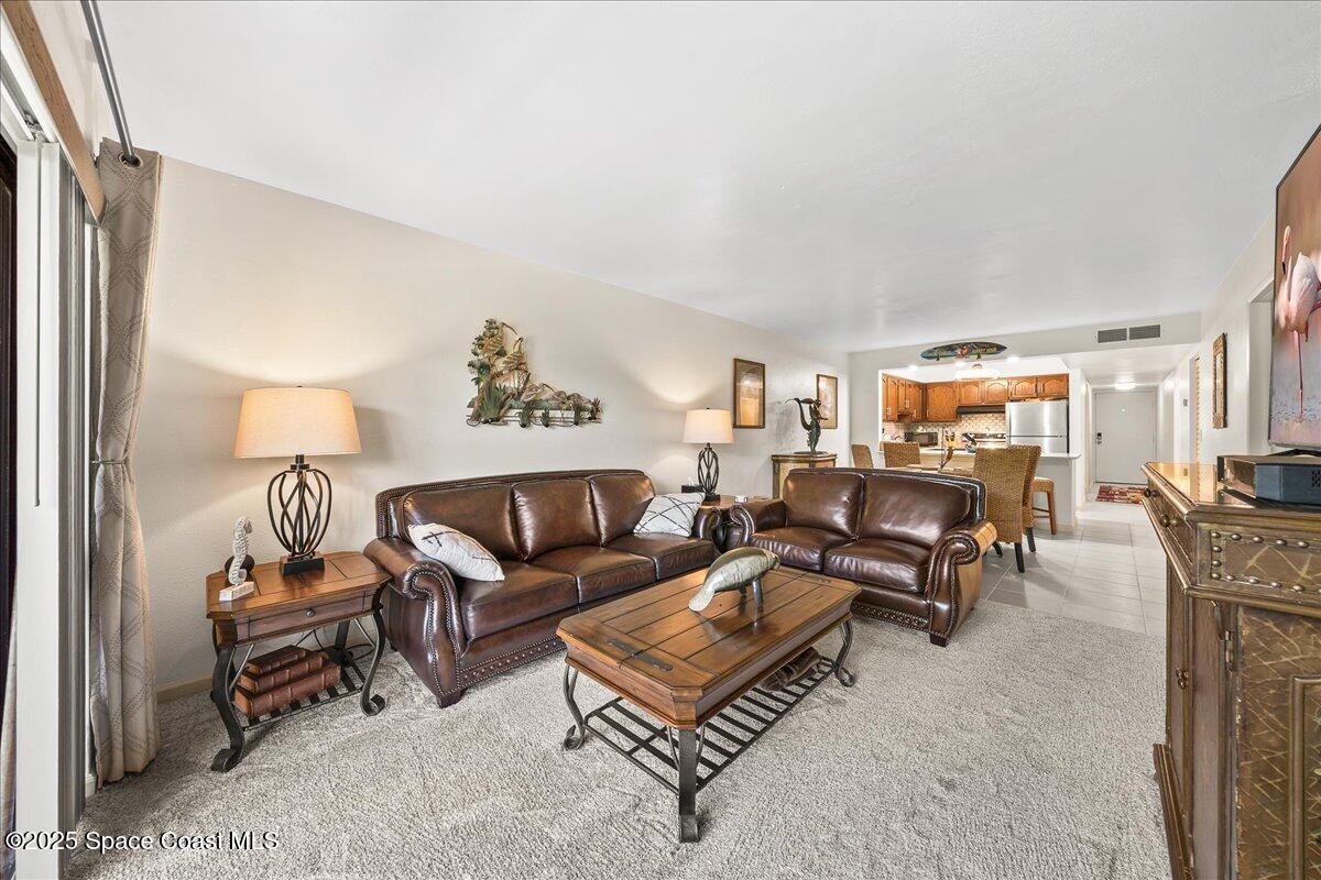 1700 South Atlantic Avenue, Unit 104 Cocoa Beach, FL 32931 - Photo 12 of 55 a living room with furniture and a couch