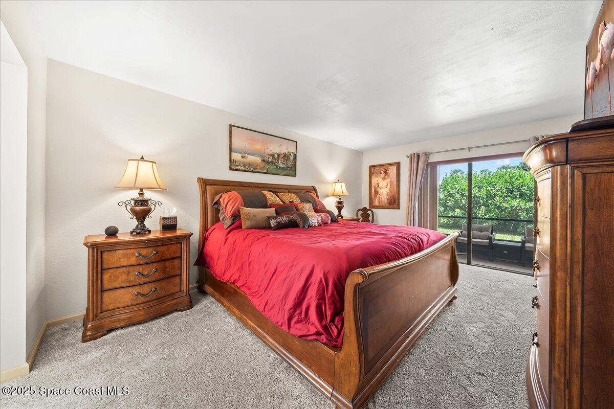 1700 South Atlantic Avenue, Unit 104 Cocoa Beach, FL 32931 - Photo 14 of 55 a bedroom with a bed and a large window