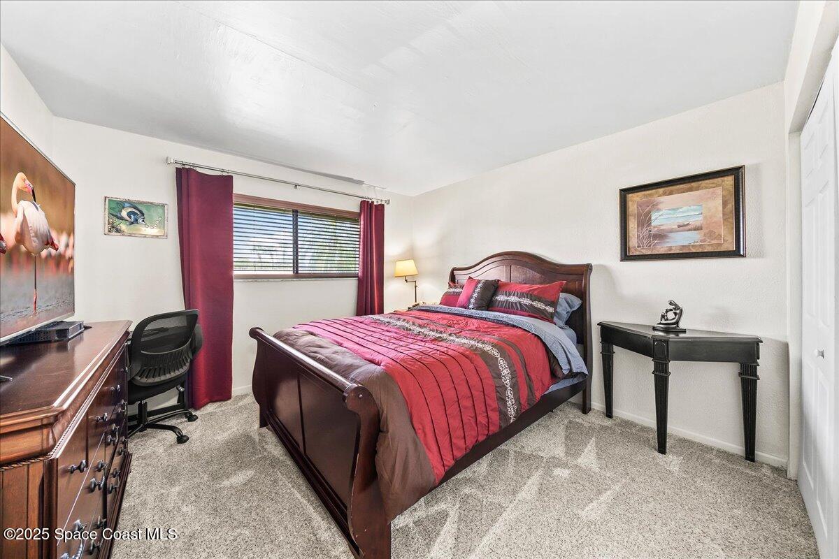1700 South Atlantic Avenue, Unit 104 Cocoa Beach, FL 32931 - Photo 19 of 55 a bedroom with a bed and a desk