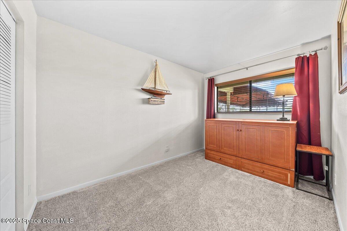 1700 South Atlantic Avenue, Unit 104 Cocoa Beach, FL 32931 - Photo 21 of 55 an empty room with windows