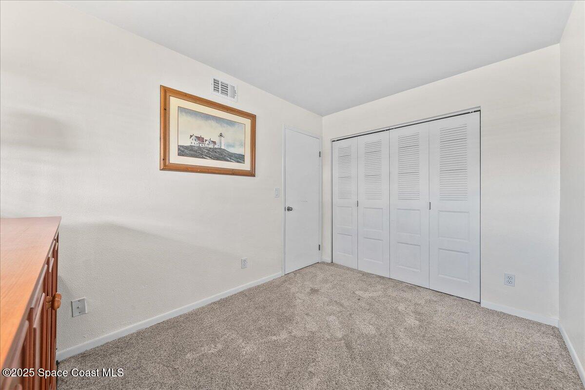 1700 South Atlantic Avenue, Unit 104 Cocoa Beach, FL 32931 - Photo 22 of 55 an empty room with a hallway