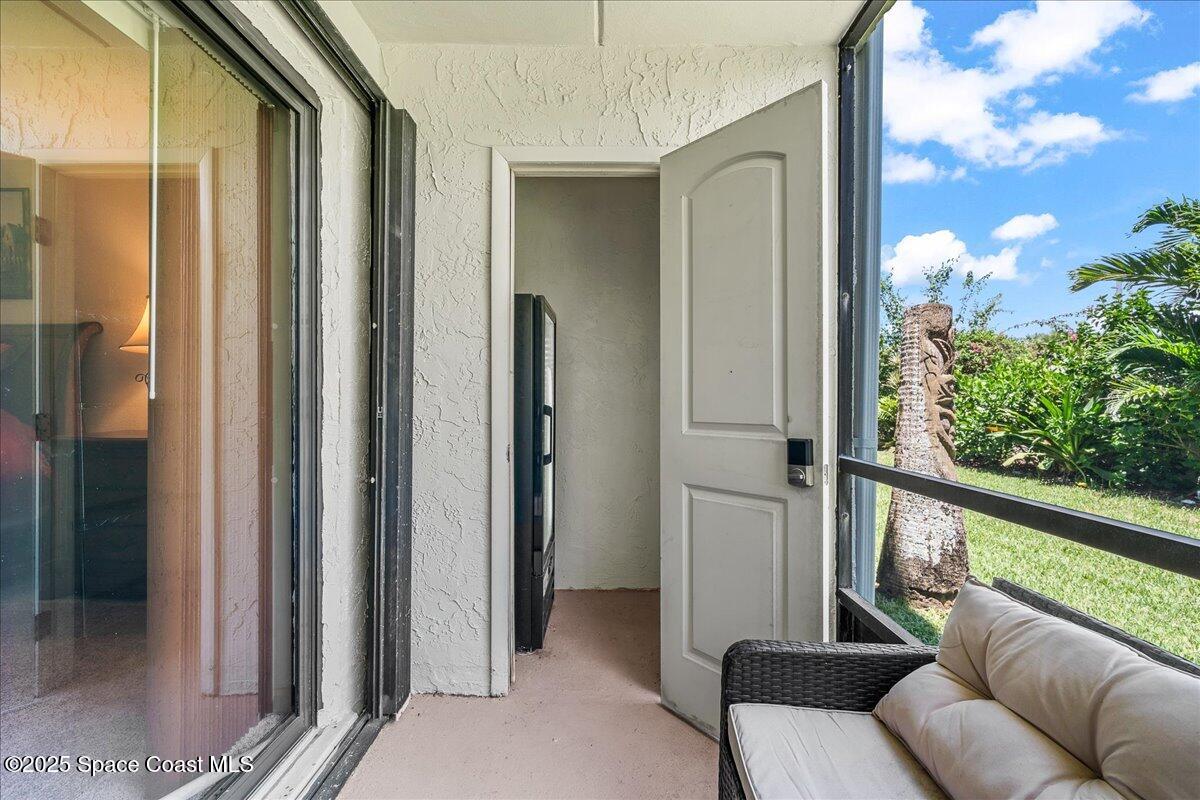 1700 South Atlantic Avenue, Unit 104 Cocoa Beach, FL 32931 - Photo 25 of 55 a balcony with furniture and a potted plant
