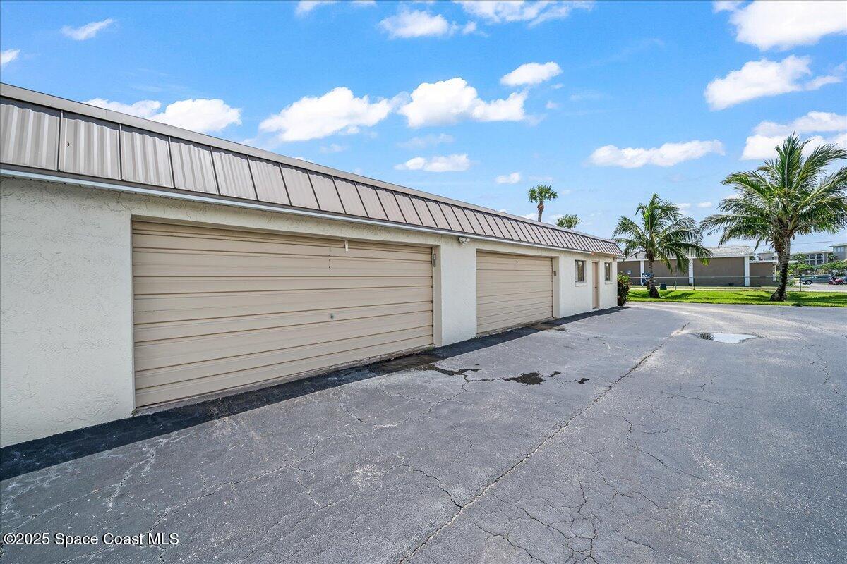 1700 South Atlantic Avenue, Unit 104 Cocoa Beach, FL 32931 - Photo 27 of 55 a view of a house with a yard