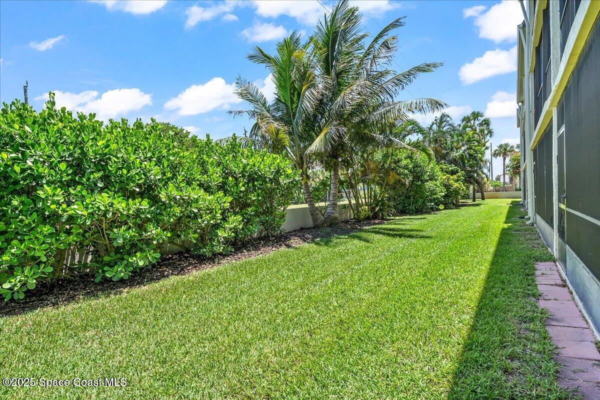 1700 South Atlantic Avenue, Unit 104 Cocoa Beach, FL 32931 - Photo 30 of 55 a view of a garden with a fountain