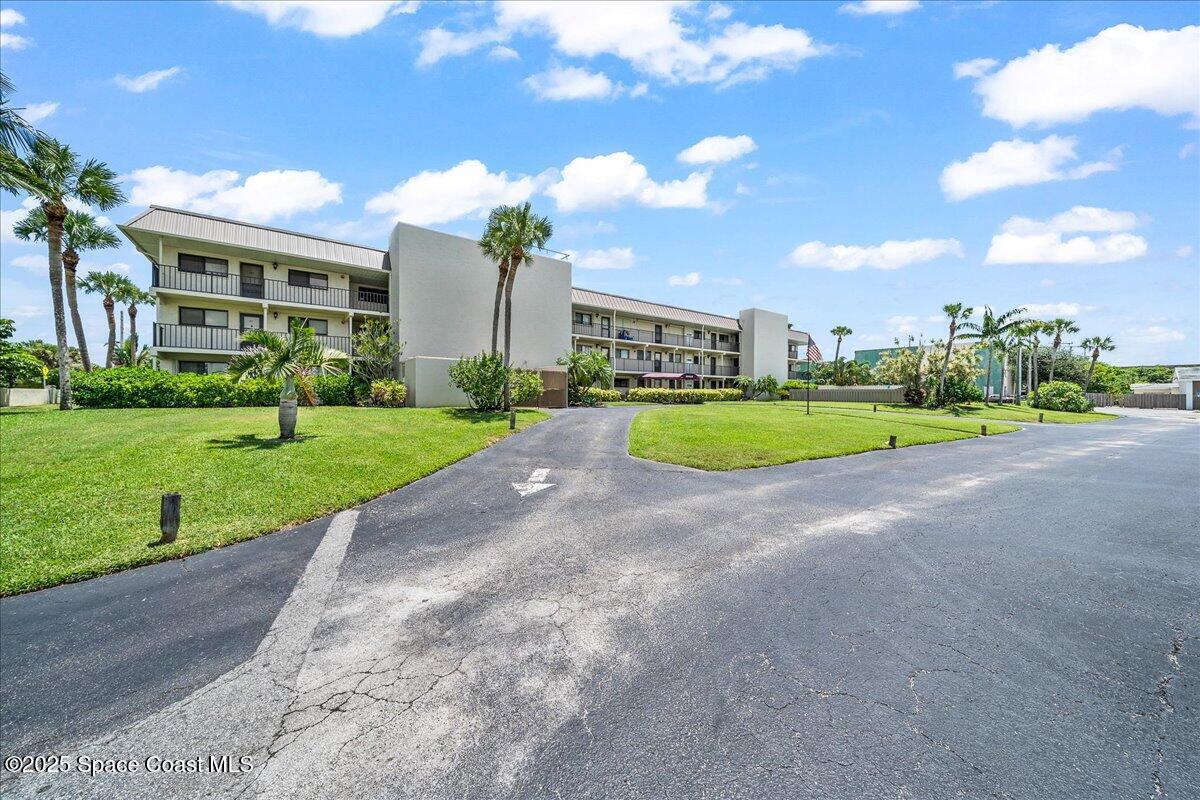 1700 South Atlantic Avenue, Unit 104 Cocoa Beach, FL 32931 - Photo 4 of 55 a view of a big room with a big yard and plants