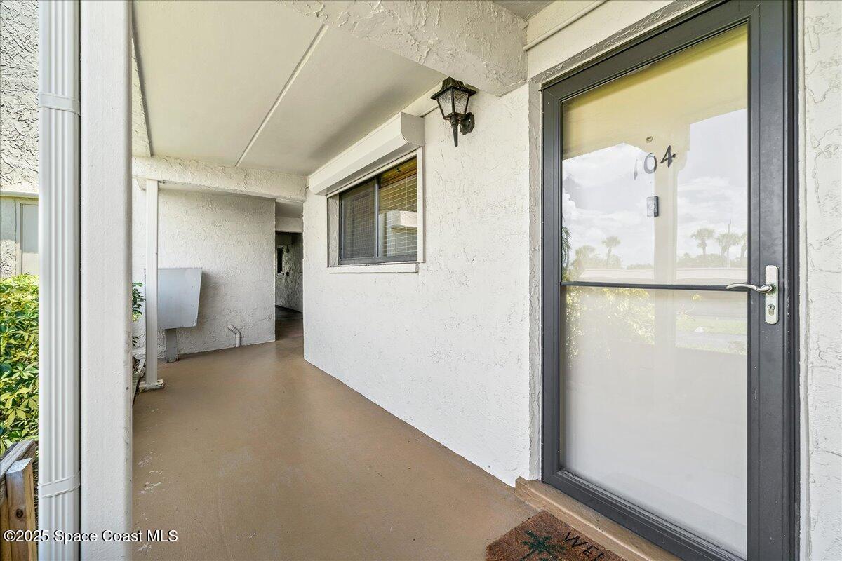 1700 South Atlantic Avenue, Unit 104 Cocoa Beach, FL 32931 - Photo 6 of 55 a view of a hallway with bathroom and a hallway