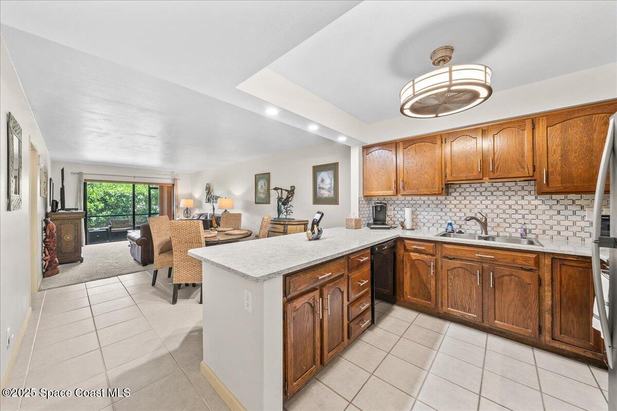 1700 South Atlantic Avenue, Unit 104 Cocoa Beach, FL 32931 - Photo 8 of 55 a kitchen with cabinets a sink and appliances