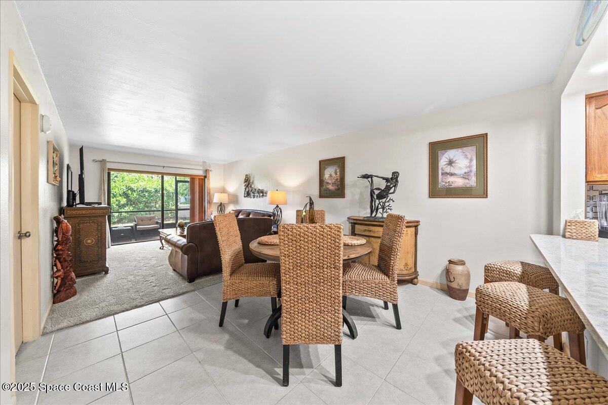 1700 South Atlantic Avenue, Unit 104 Cocoa Beach, FL 32931 - Photo 10 of 55 a living room with furniture and a window