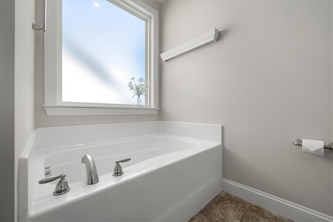 21 Barron Glenn Way Anderson, SC 29621 - Photo 31 of 48 Relax in this pristine white fiberglass soaking tub, nestled beneath a large, private window.