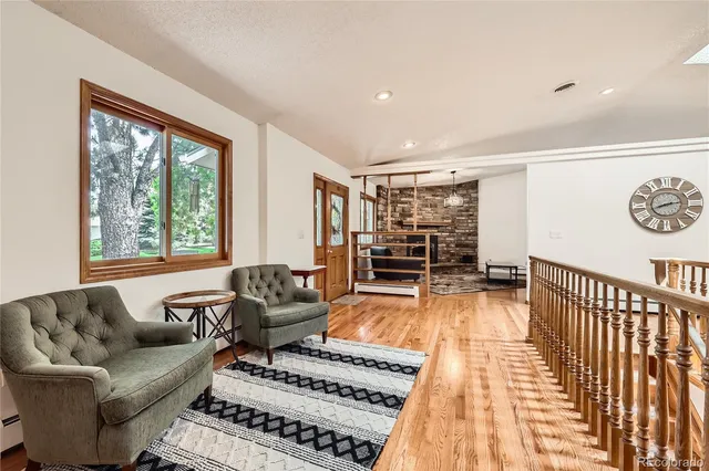 a living room with furniture a rug and a large window