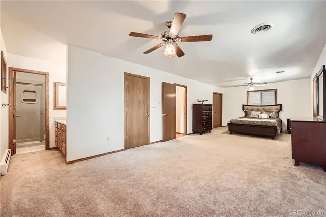 a view of an empty room with a ceiling fan