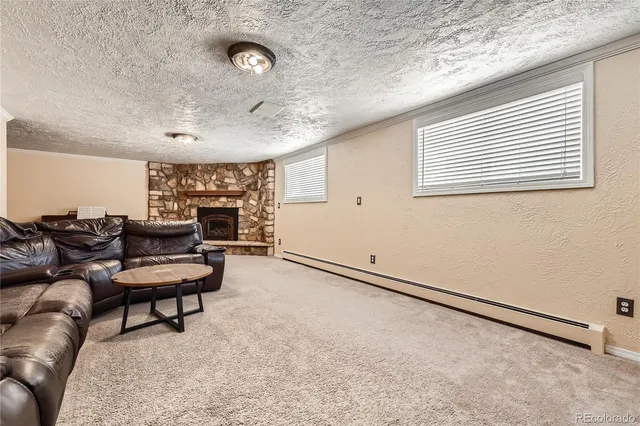 a living room with furniture and a ceiling fan
