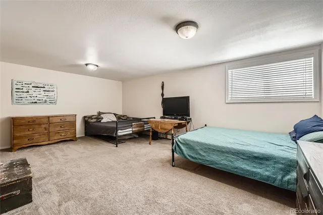 a bedroom with bed and a flat screen tv
