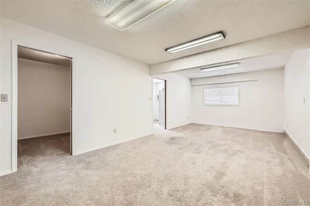 an empty room with a empty space and windows