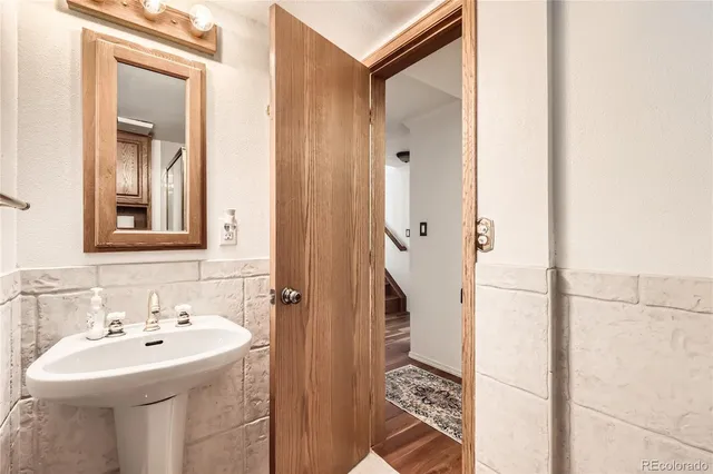 a bathroom with a sink a mirror and shower