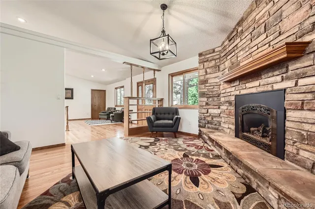a living room with furniture a fireplace and a table