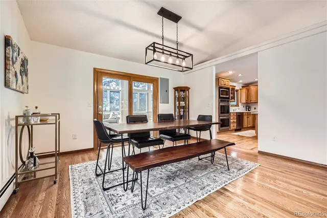 a living room with furniture a window and wooden floor